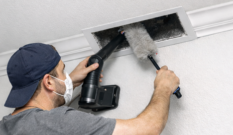 homeowner performing DIY air vent clean